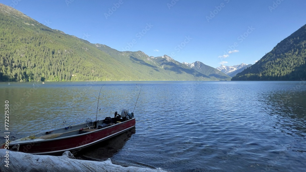 Fishing boat on Chilliwack Lake with majestic mountains in the background. BC, Canada.