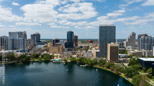 Downtown Orlando skyline overlooking the tranquil Lake Eola Park with its iconic fountain and urban backdrop.