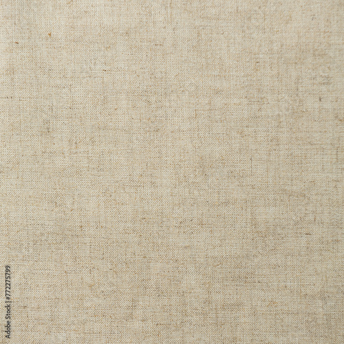 Texture, background, pattern. The fabric is knitted woolen beige color with a slight roughness photo