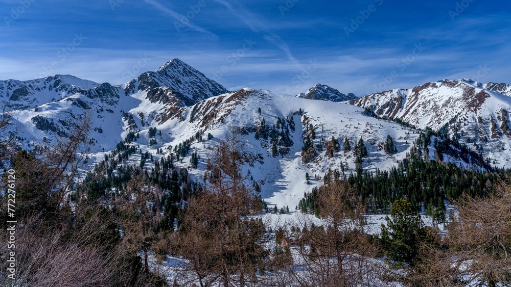 Scenic view of a mountain range against a blue sky in Hohentauern, Styria, Austria.