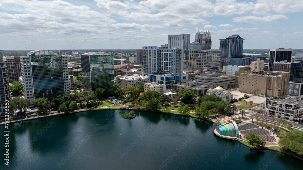 Downtown Orlando skyline overlooking the tranquil Lake Eola Park with its iconic fountain and urban backdrop.