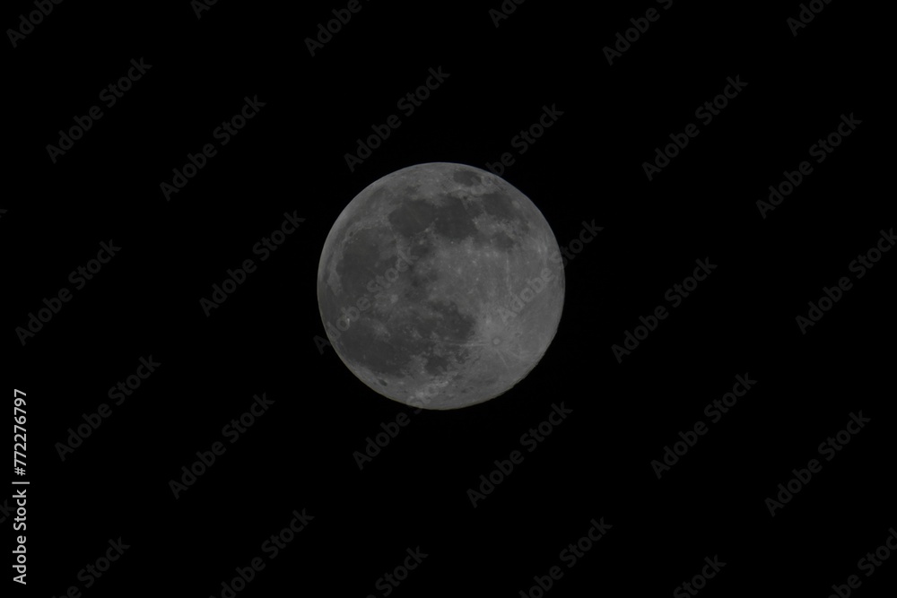 Stunning image of a large full moon illuminating the night sky Stunning image of a large full moon illuminating the night sky