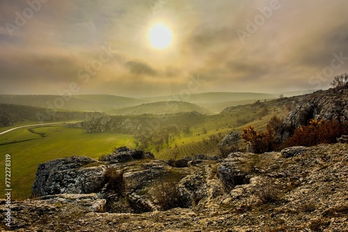 A countryside landscape with Dobrogea Gorges in Dobruja, Romania and sunlight coming from the clouds photo