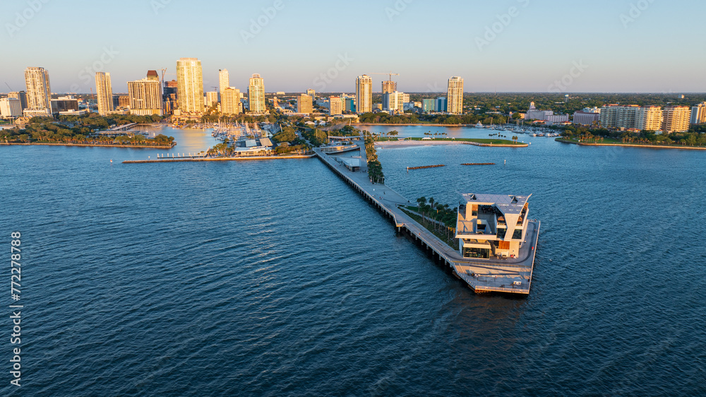 Sunrise at Saint Petersburg, Florida pier with downtown skyline in the background, aerial perspective.