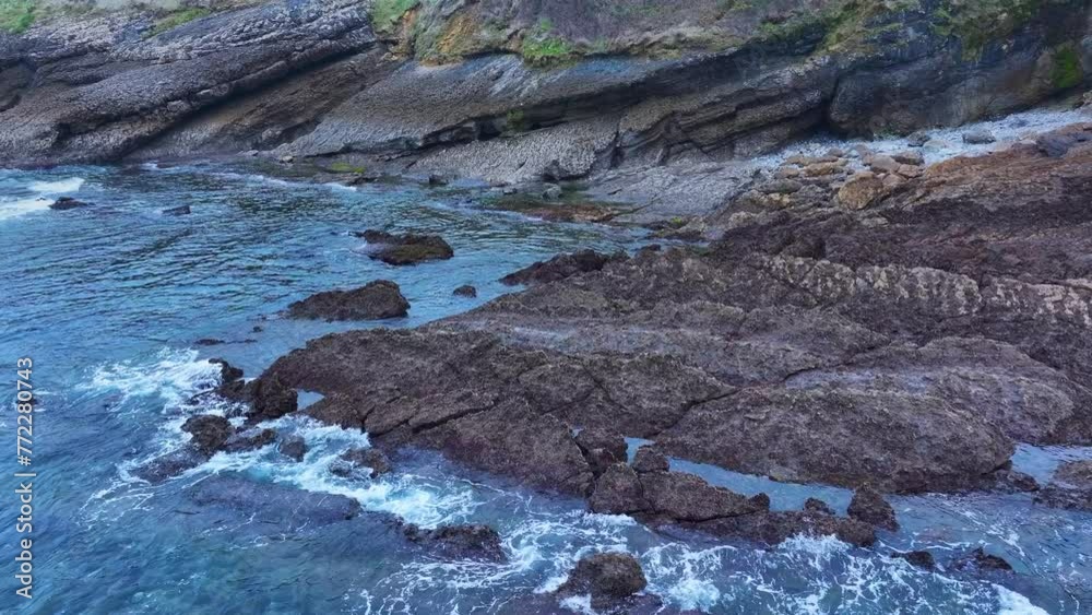 Rock formations and coastal landscape around the town of Comillas. Aerial view from a drone. Comillas Municipality. Cantabrian Sea. Cantabria. Spain. Europe Rock formations and coastal landscape around the town of Comillas. Aerial view from a drone. Comillas Municipality. Cantabrian Sea. Cantabria. Spain. Europe