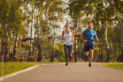 Fototapeta Naklejka Na Ścianę i Meble -  Happy couple engages in a refreshing jog in the city park. Runners smiles reflect the shared happiness of embracing an jogging. Together, they find joy in the simple yet invigorating act of sport jog.