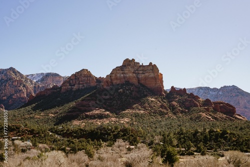 Scenic landscape featuring red rock formations against blue sky in Sedona, Arizona