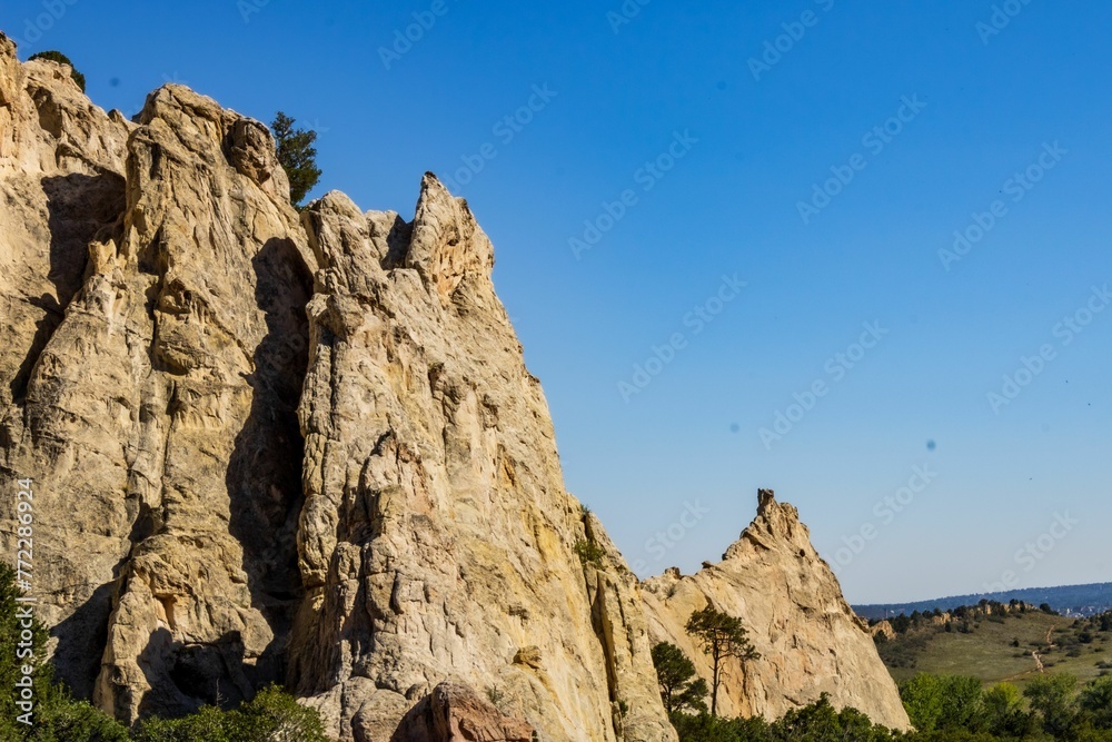 Aerial view of rugged rock formations majestically against a pristine blue sky in Colorado