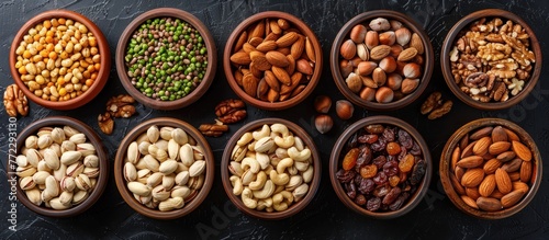 Multiple bowls filled with a variety of nuts such as pecans and pistachios, creating a display of diverse nut options.