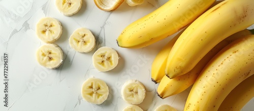 A bunch of bananas placed on top of a table, showcasing their vibrant yellow color and appealing shape. photo