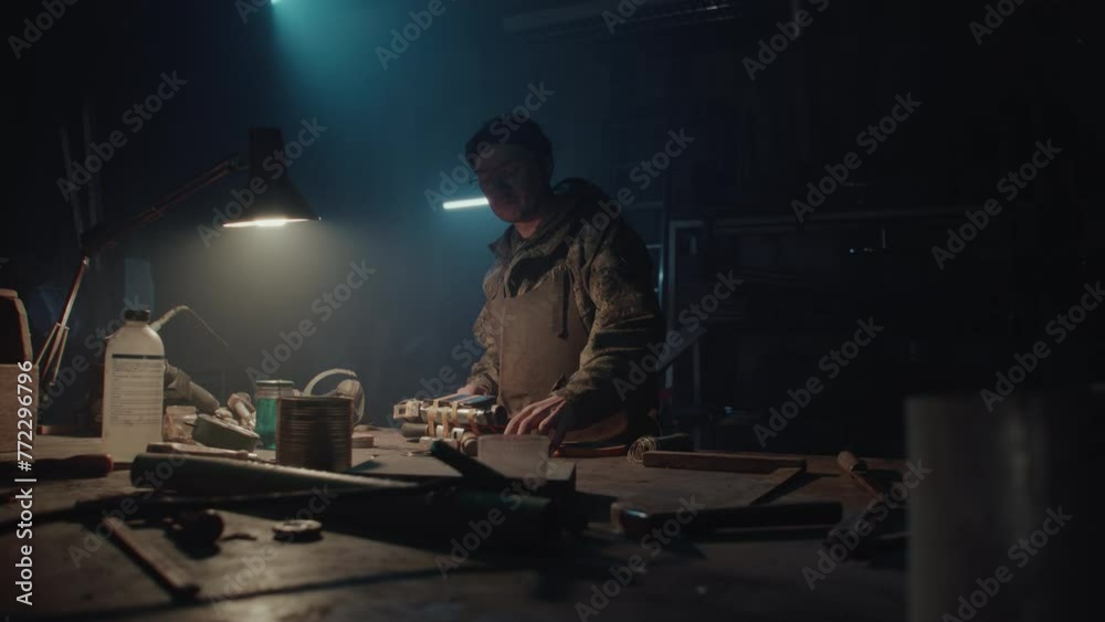 A man builds a bomb in his workshop at night A man builds a bomb in his workshop at night