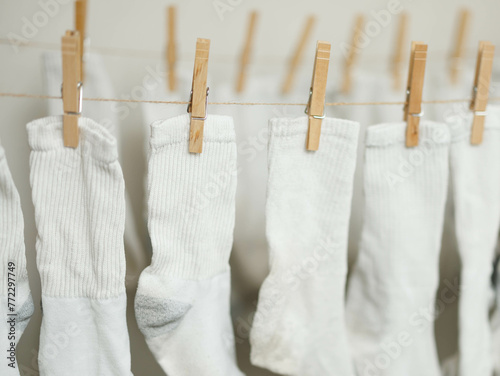 White socks clipped to rope to dry