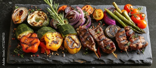 Various grilled vegetables arranged neatly on a dark slate cutting board.