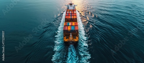 A large container ship plows through the open ocean, carrying goods across vast distances in a vast metal vessel.