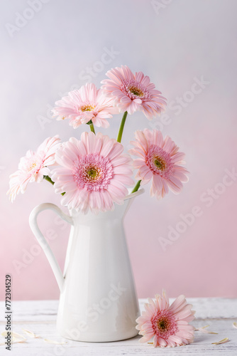 Vertical closeup of pink gerberas in bottle © powerstock