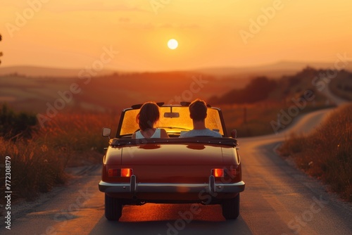 A couple in love on a open-top car at sunset