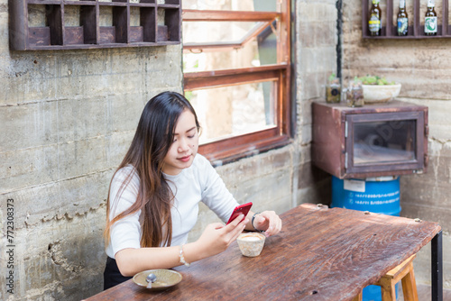 Beautiful business asian woman use smartphone business communication sitting in coffee shop