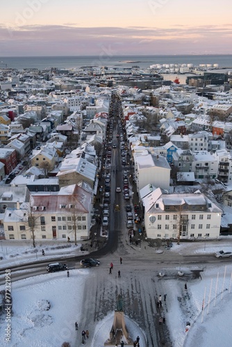 a large town filled with lots of snow covered trees and other houses photo