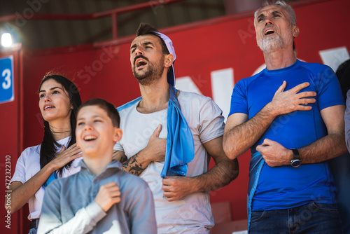 Football / soccer fans singing anthem at the stadium