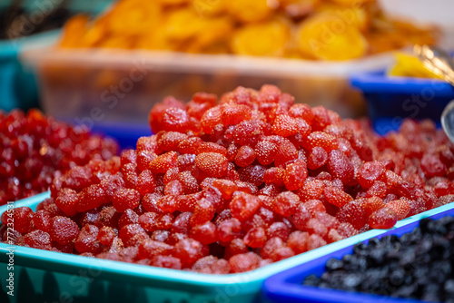Colourful redberry fruits for sale on display at trade fair. photo