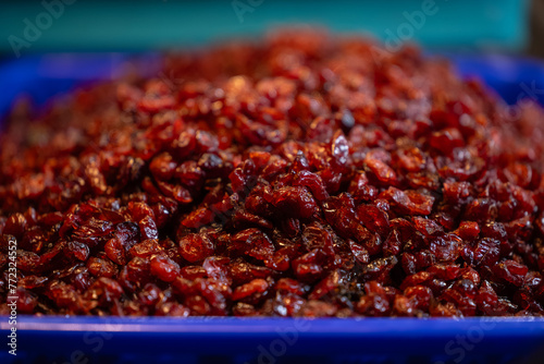 Colourful redberry fruits for sale on display at trade fair. photo