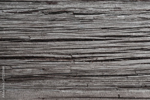 Texture of old weathered cracked gray wooden board
