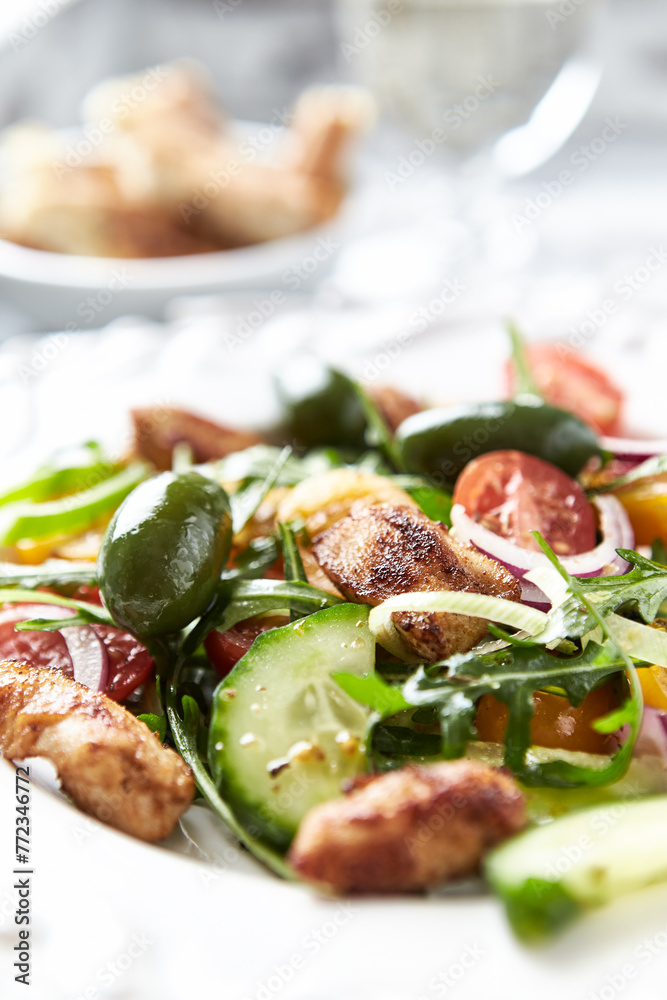 Healthy Salad with Chicken Breast, Cherry Tomatoes, Cucumber, Rocket and Green Olives. Close up.	