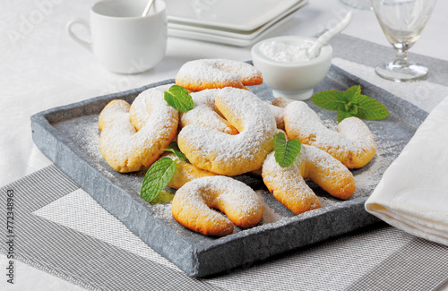 Austrian vanilla cookies in the shape of half moons sprinkled with icing sugar.. photo