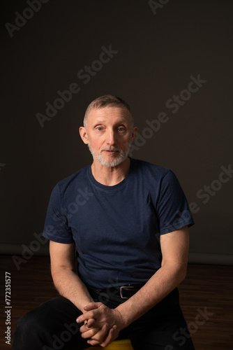 an authentic portrait of an elderly man with a beard in the studio, selective focus