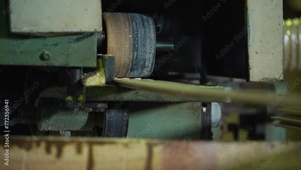 Industrial machine is processing lumber planks at the woodworking factory. Processing machine is producing wooden planks. Automated Wood Processing machine is manufacturing long timber planks. Industrial machine is processing lumber planks at the woodworking factory. Processing machine is producing wooden planks. Automated Wood Processing machine is manufacturing long timber planks.