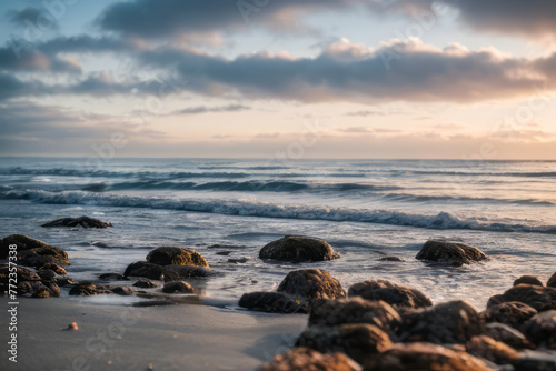 Sunset on the beach with fiery sky and calm ocean waves