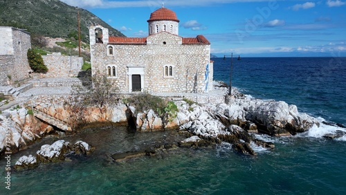 Obraz na płótnie Church by the sea in the beauty of nature and the sea coast of the Peloponnese, Mani Lakonia - uncontaminated nature and blue sea where you can spend your summer holidays - drone aerial view w salonie