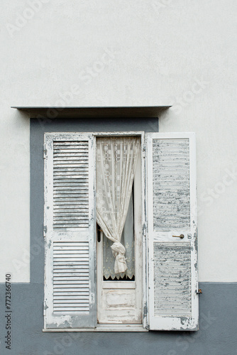 Minimal travel concept. Window with wood shutters on building. Front view. Europe