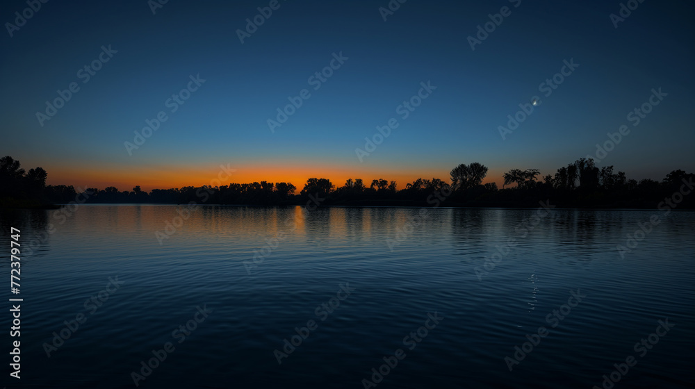 Tranquil River Sunset with Reflective Water and Orange Horizon