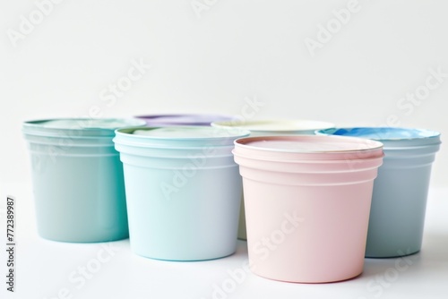 containers with pastel paint with space for logos or text Isolated on solid white background