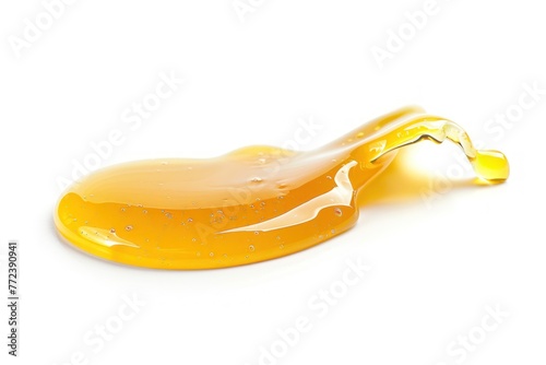 Drop of honey or other yellow liquid isolated on white background