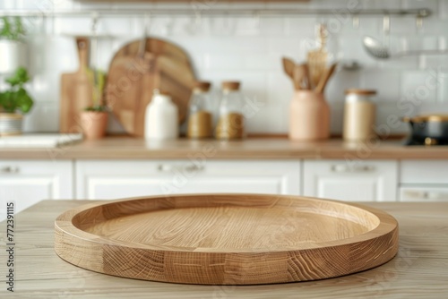 Empty round wooden tray on kitchen counter against kitchen background with space for product or text