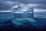 Iceberg floating on dark sea, large part visible underwater, smaller tip above surface