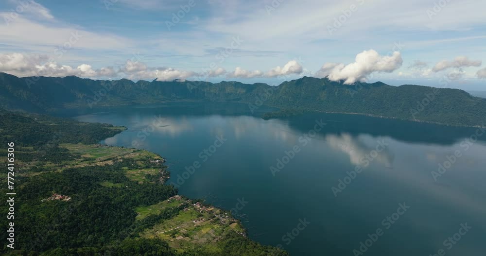 Aerial drone of blue lake Maninjau in a crater among the mountains. Sumatra, Indonesia. Aerial drone of blue lake Maninjau in a crater among the mountains. Sumatra, Indonesia.