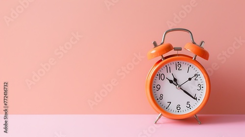 orange vintage alarm clock on pink color background