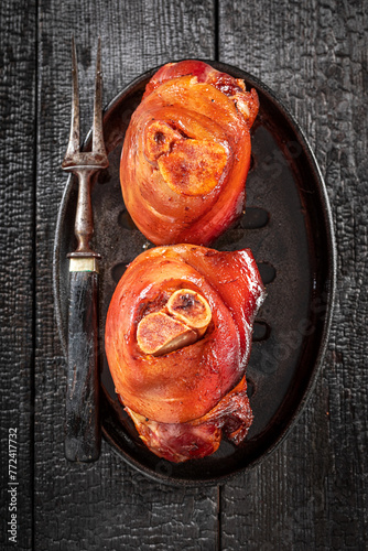 Photography Roasted and fat ham hock with spices and garlic.