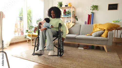 African American woman in a wheelchair taking care of her baby