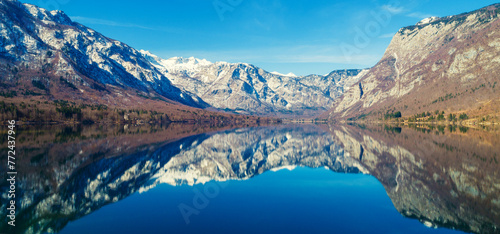 Mountain lake with reflection. Nature landscape. Lake Bohinj, Slovenia, Europe. Horizontal banner