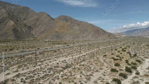 4K Aerials of the windmill farm in Palm Springs, California at the foot of the San Jacinto Mountains, adjacent to Highway 111, which helps provide energy for the Coachella Valley in Riverside County.