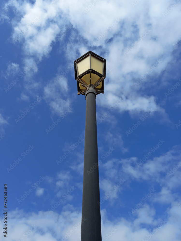 Classic street lamp under blue sky. View from below of Walkway garden ground lamp. Outdoor vintage lamppost.