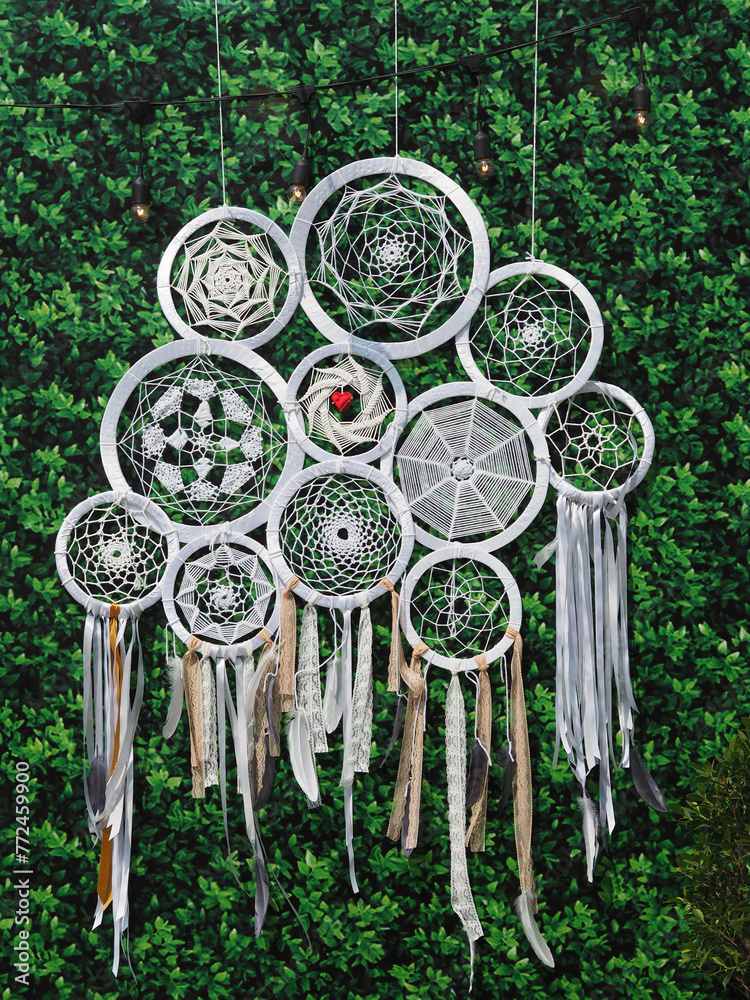 Closeup Shot of Dream Catchers Decorated on Green Background.