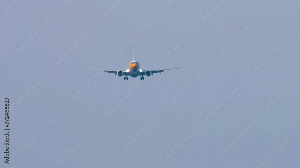 Jet airplane approaching before landing at Phuket airport. The airplane flies, front view. Travel concept Jet airplane approaching before landing at Phuket airport. The airplane flies, front view. Travel concept