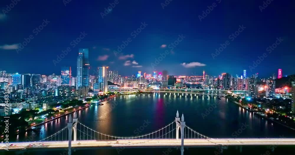 Macau city skyline and bridge with river at night, aerial forward shot Macau city skyline and bridge with river at night, aerial forward shot