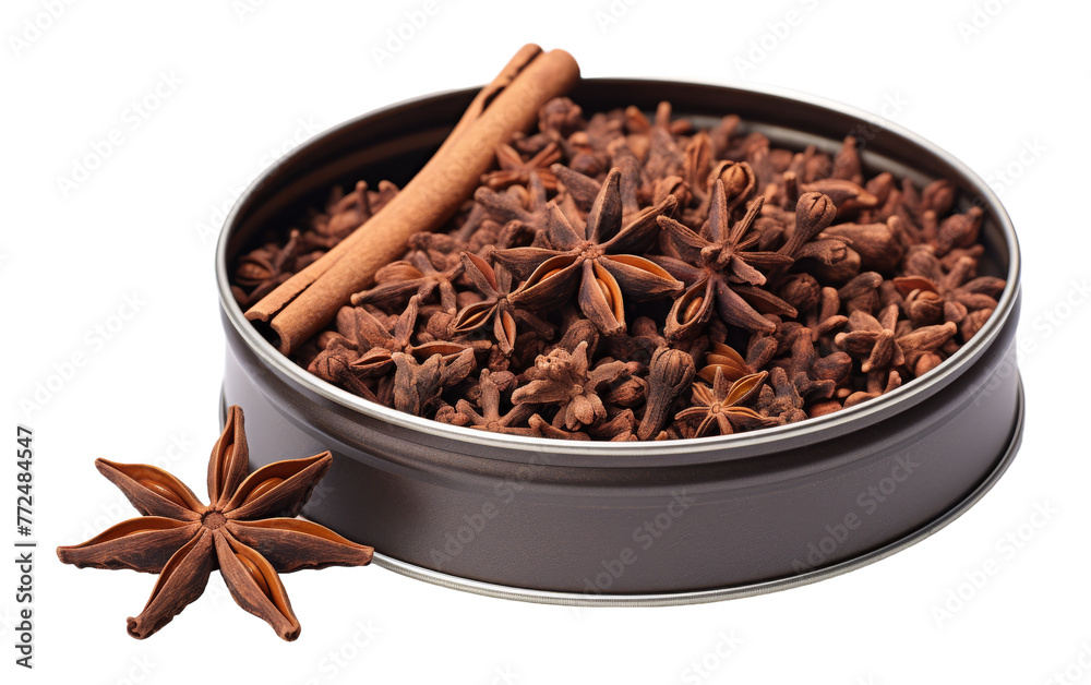 Anise and cinnamon spices delicately layered in a tin Anise and cinnamon spices delicately layered in a tin