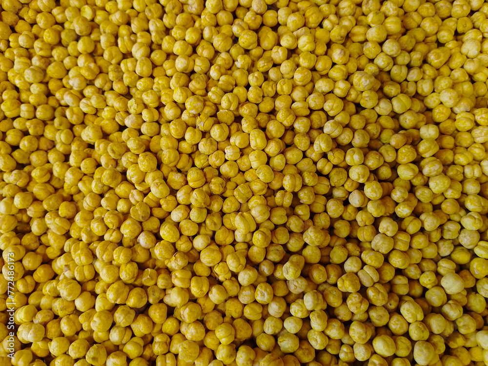 Roasted and spicy yellow chickpeas top view background Roasted and spicy yellow chickpeas top view background